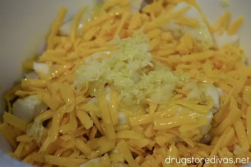 Cheese, garlic, oil, and biscuits in a bowl.