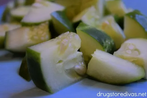 Cubed cucumber on a cutting board.