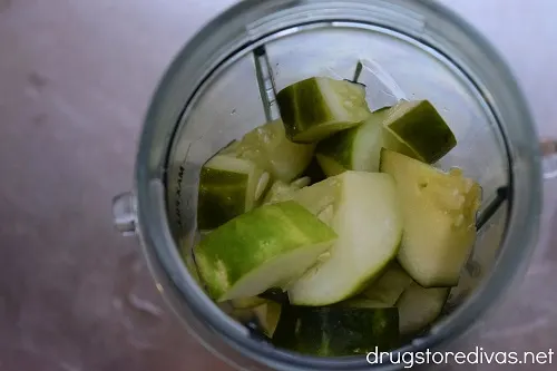 Cubed cucumber in a blender cup.
