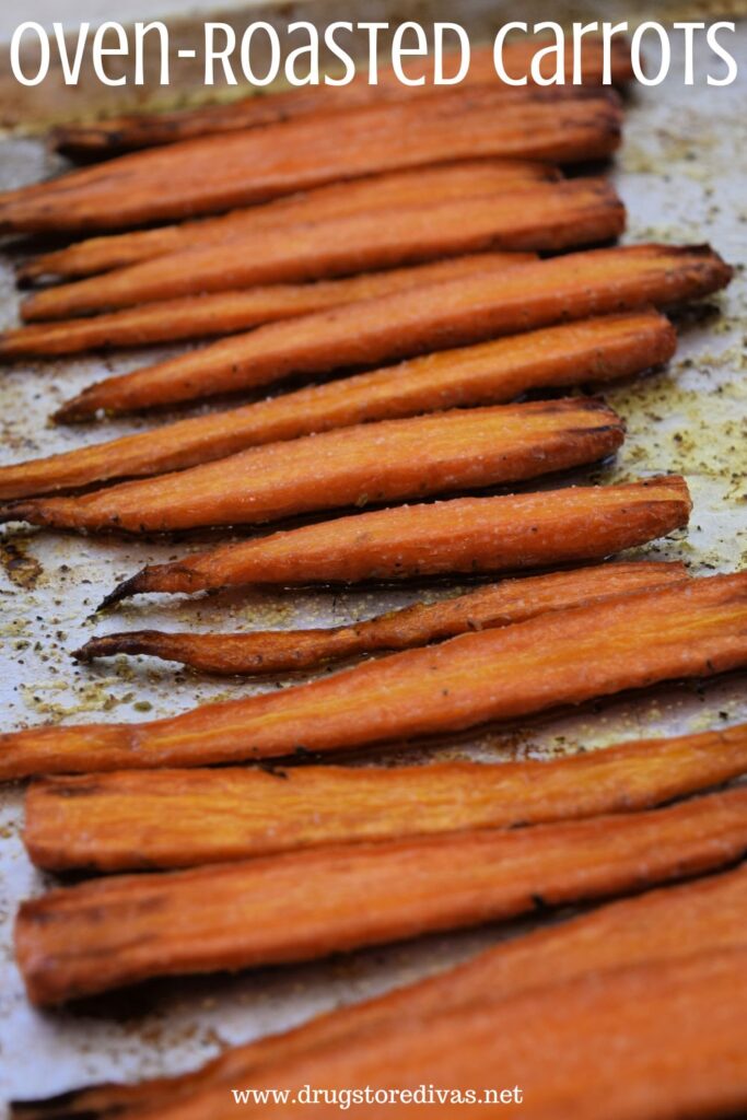 Cooked carrots on a sheet pan with the words "Oven-Roasted Carrots" digitally written on top.