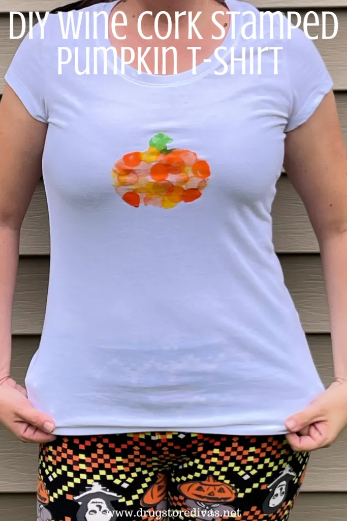 A woman wearing a homemade pumpkin shirt with Halloween leggings and the words "DIY Wine Cork Stamped Pumpkin T-Shirt" digitally written on top.