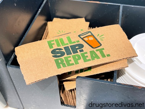 A paper coozie with the words "Fill. Sip. Repeat." on it.