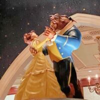 Ceramic figurines of Belle and The Beast from Beauty and the Beast dancing with the words 