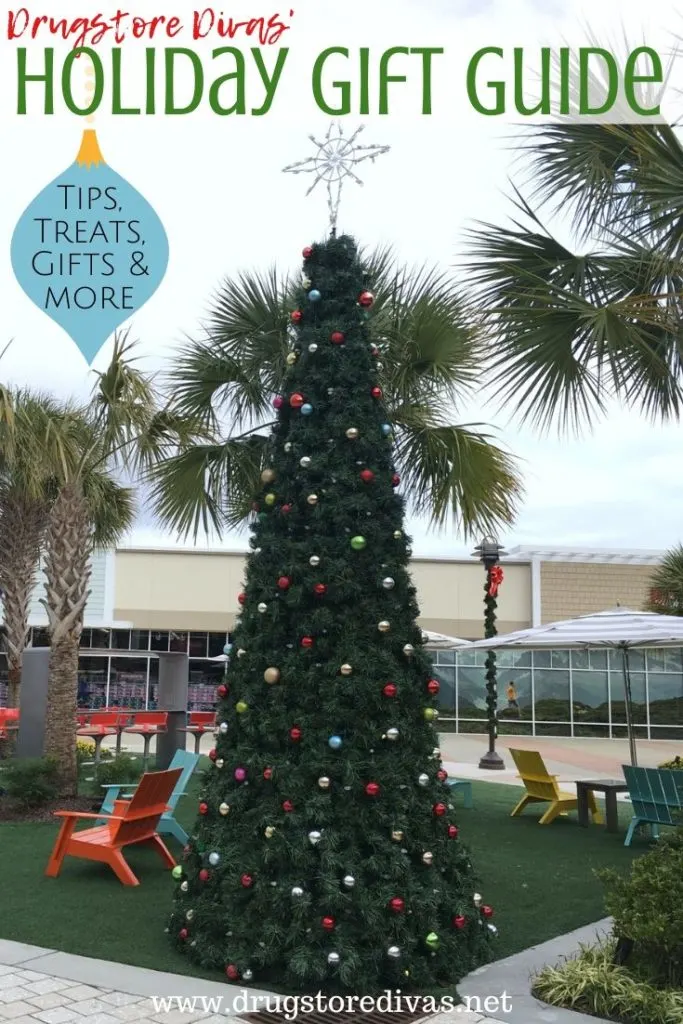 A Christmas tree in a shopping mall with the words "Drugstore Divas' Holiday Gift Guide" digitally written above it.