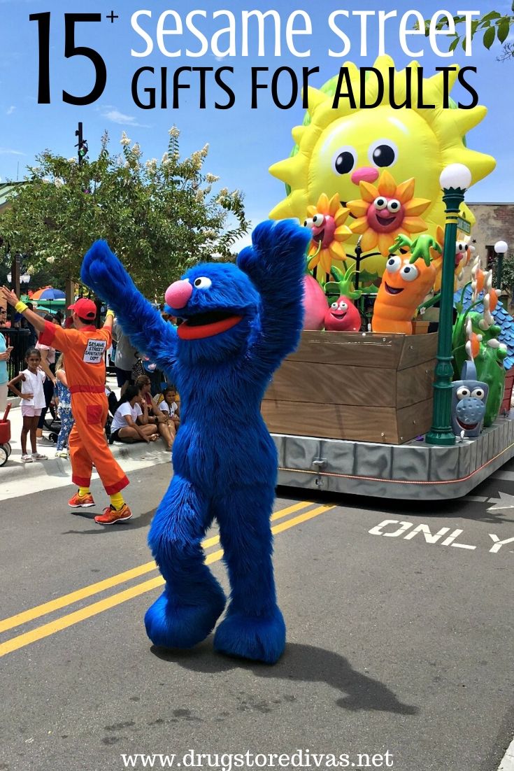 Grover from Sesame Street marching in a parade followed by a Veggie Tales float with the words "15+ Sesame Street Gifts For Adults" digitally written on top.