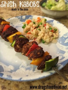 Chicken shish kabobs on a plate next to rice.