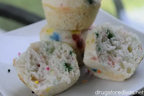 Funfetti muffins stacked on a plate.