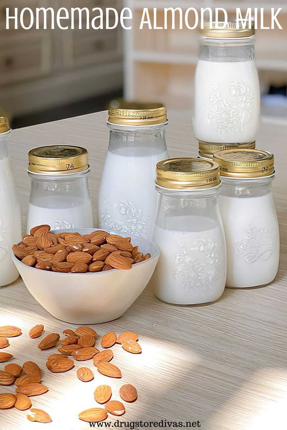 A bowl of almonds surrounded by bottles of milk and the words "Homemade Almond Milk" digitally written on top.