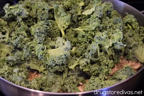 Kale in a silver skillet.
