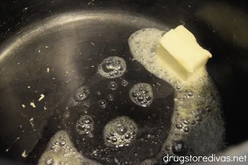 A pat of butter melting in a pot.