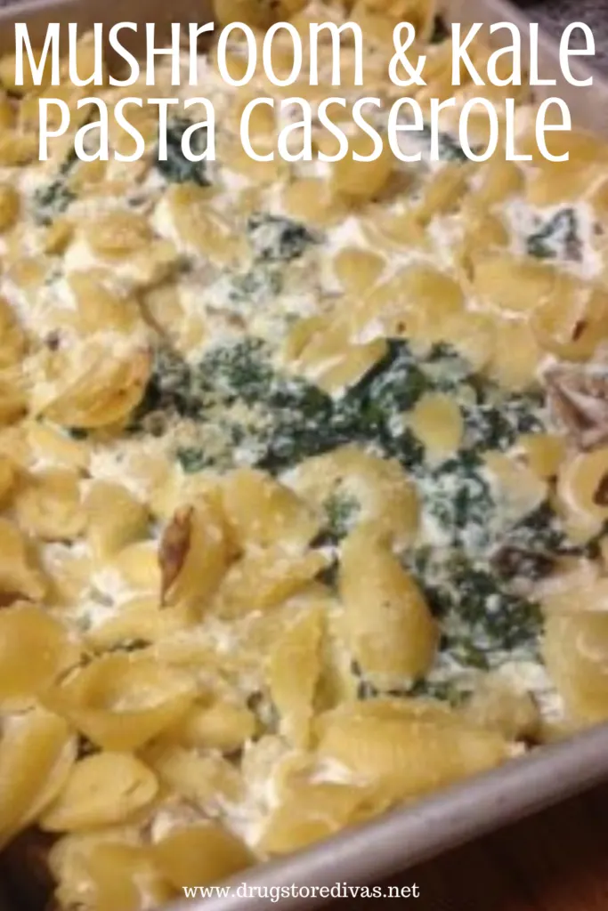 Shell pasta, kale, and ricotta cheese in a pan with the words "Mushroom & Kale Pasta Casserole" digitally written on top.