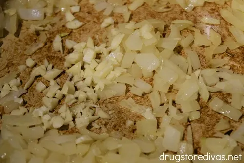 Diced onions and garlic in the bottom of a Dutch oven.