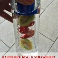An infused water bottle with raspberry, kiwi, and strawberry inside and the words 