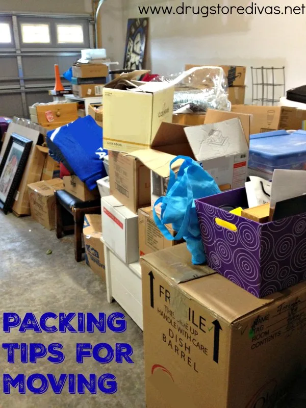 Moving boxes in a garage with the words "Packing Tips For Moving" digitally written below them.