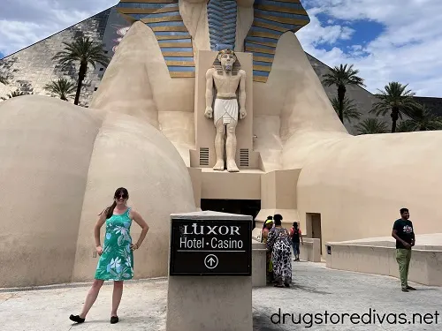 A woman in a teal dress in front of the entrance to Luxor in Las Vegas.