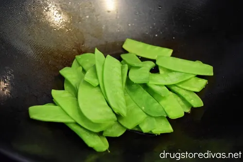 Snow peas in a wok.