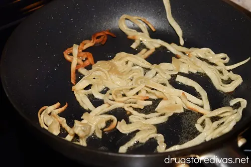 Strips of fried wonton wrappers in a pan.