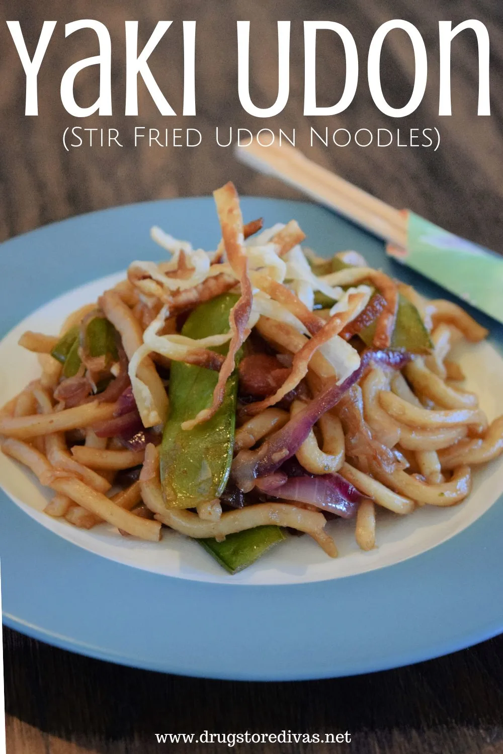 Noodles with snow peas and red onions on a blue and white plate with chopsticks on the side and the words 
