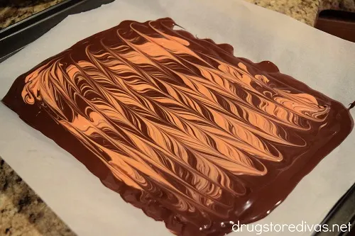 Melted orange and brown chocolate swirled together.