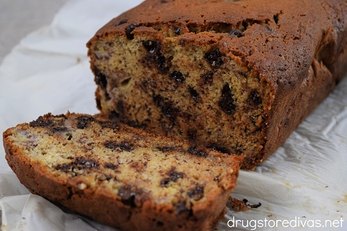 A loaf of Chocolate Chip Banana Bread with one slice cut.