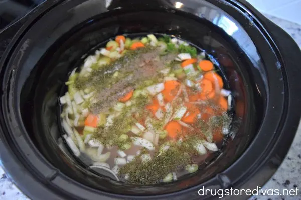 Chicken soup ingredients in a slow cooker.