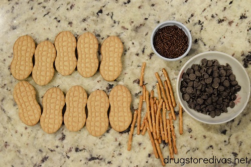Nutter Butter cookies, chocolate sprinkles, thin pretzel rods, and chocolate chips.