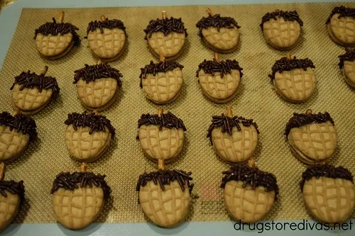 Nutter Butter Acorn Cookies on a silicon baking mat.