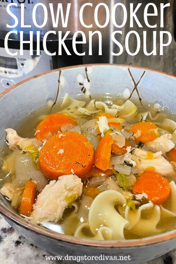 A bowl of soup with chicken, noodles, and carrots in front of a slow cooker with the words "Slow Cooker Chicken Soup" digitally written on top.