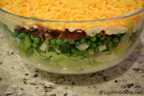 Looking for the ultimate BBQ, tailgate, or pot luck recipe? You'll score a win with this 7 layer salad from www.drugstoredivas.net.