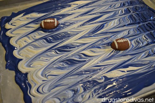 Blue and white candy bark with gummy football candies in it.