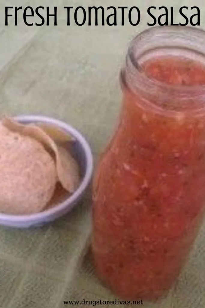A glass jar filled with salsa next to a small bowl of round tortilla chips with the words "Fresh Tomato Salsa" digitally written on top.