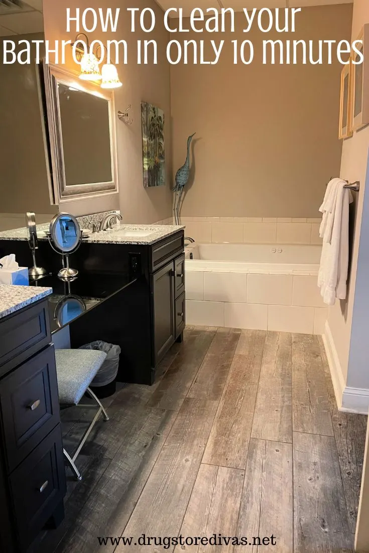 A bathroom with a double vanity on the left and a bath rub in the back with the words 
