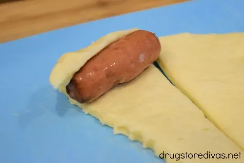 Cocktail wiener on a crescent roll.