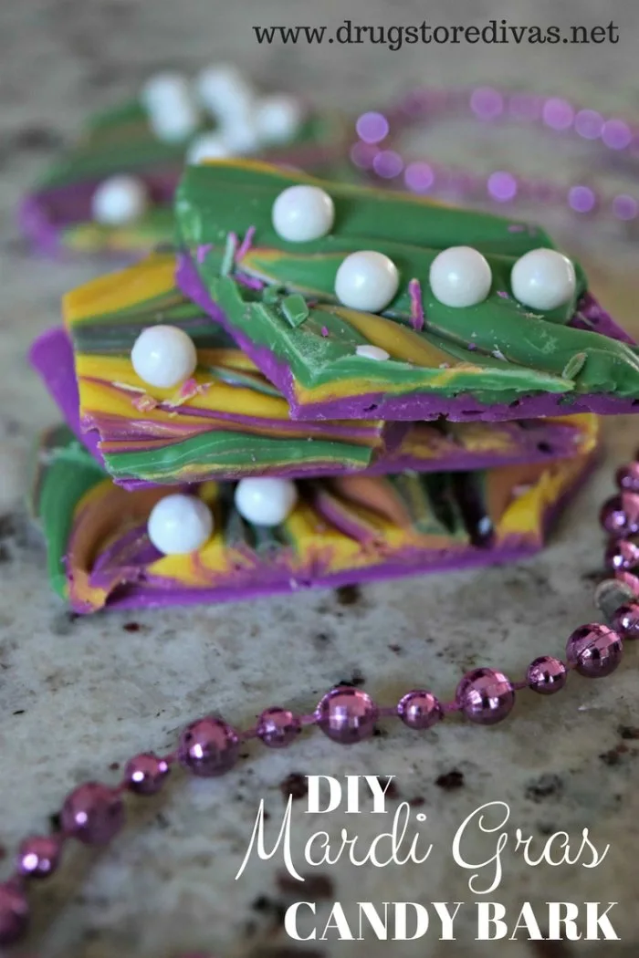 Green, purple, and yellow candy bark with white pearls in it and the words "DIY Mardi Gras Candy Bark" digitally written below it.