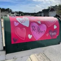 A mailbox wrapped with a Valentine's Day Conversation hearts wrapped with the words 