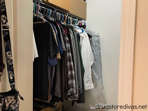 Clothes hanging on hangers in a closet.
