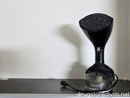 A black handheld steamer.
