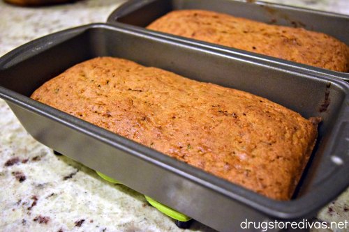 Two loaves of zucchini bread in bread pans.