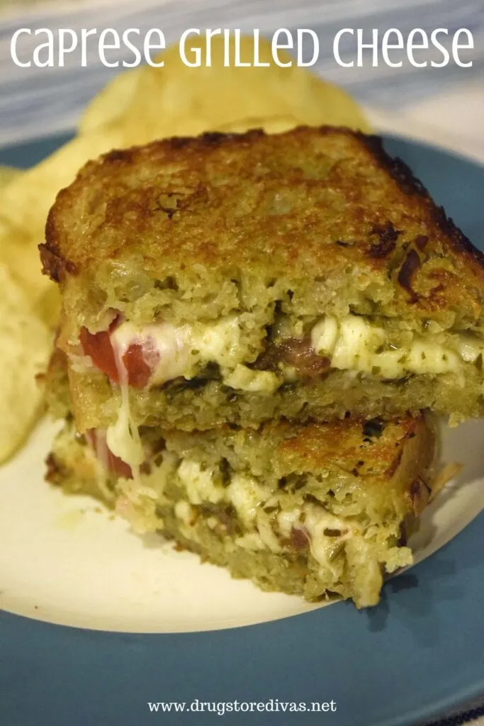 A Caprese Grilled Cheese sandwich on a plate with chips and the words "Caprese Grilled Cheese" digitally written on top.