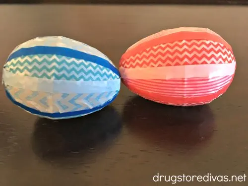 Two plastic Easter eggs decorated with washi tape.