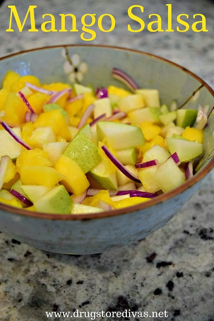 Pear, mango, and onion in a bowl with the words "Mango Salsa" digitally written on top.