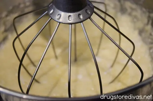 White cake mix batter in a stand mixer bowl.