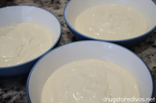 Three bowls filled with white cake mix batter.