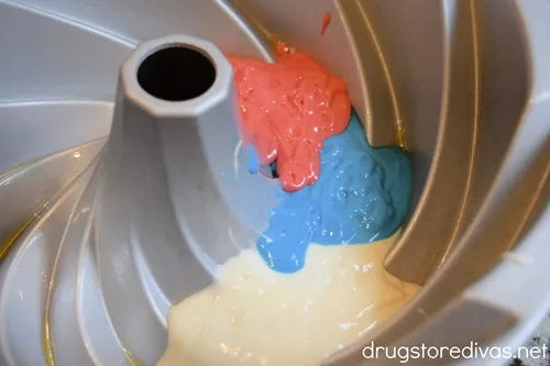 Red, blue, and white cake batter in a Bundt pan.