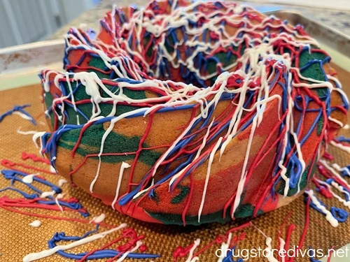 A red, white, and blue Bundt cake on a cookie sheet.