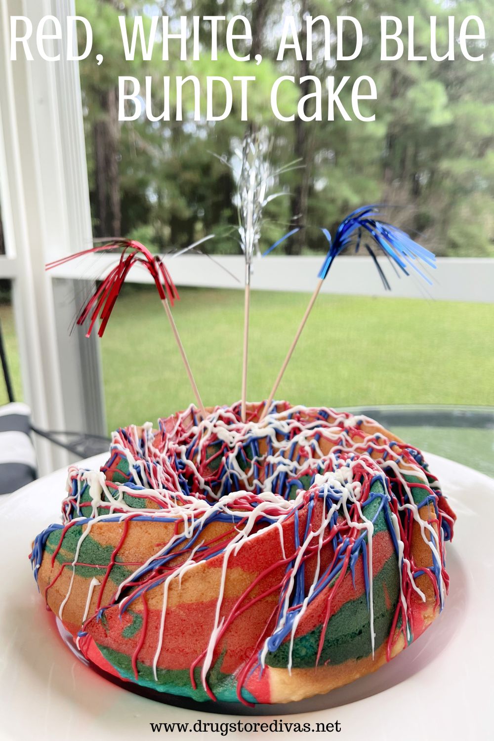 A tricolored bundt cake on a white plate with metallic skewers out the top and the words 