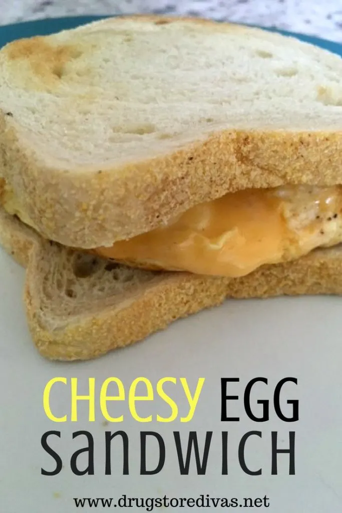 A sandwich with egg and cheese on it and the words "Cheesy Egg Sandwich" digitally written below it.