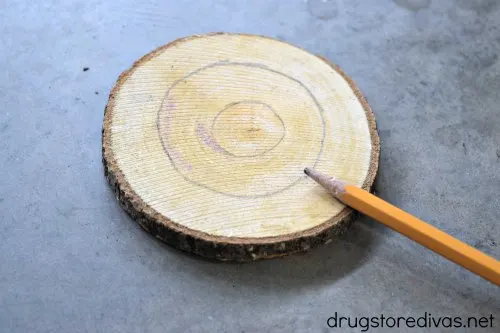 Two circles drawn on a circle piece of wood.