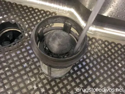 A dishwasher filter in a sink.