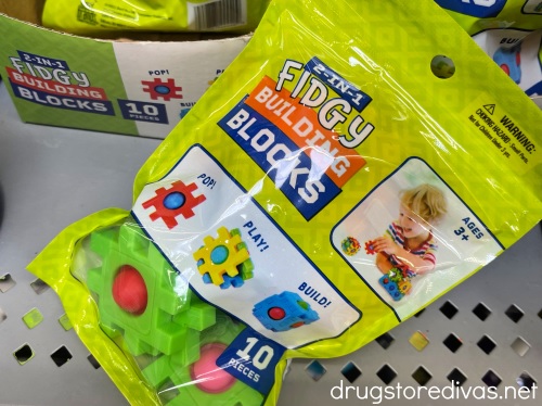 A bag of unopened Fidgy Building Blocks on a shelf in the store.